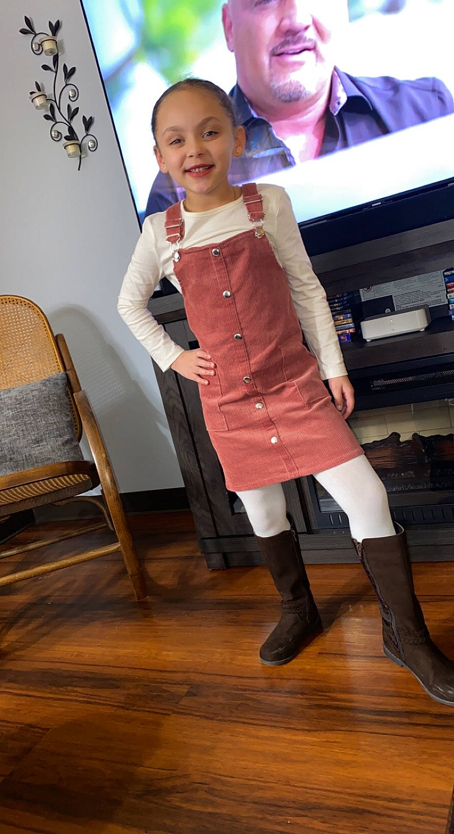 Eleina is registered to the contest to win money with this photo: chair, event, fashion_design, flooring, fun, furniture, hairstyle, happy, hardwood, headwear, human_leg, joy, knee, long_hair, person, sleeve, smile, sock, thigh, toddler