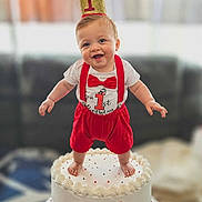 Braxton joined the competition — help win amazing prizes! baby, birthday, cake, first_birthday, crown, red_clothing, smiling, happy, celebration, party, child, indoors, one_year_old, festive, cute, person, face, feet, white_cake, decorations