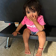 Lily is registered to the contest to win money with this photo: ankle, bodypart, child, clothing, face, female, finger, furniture, girl, hand, head, person, photography, plywood, portrait, sad, shorts, sitting, toe, wood
