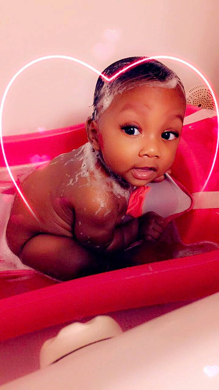 Janiah is registered to the contest to win money with this photo: baby, bathing, bathtub, cheek, child, doll, eyebrow, face, forehead, hair_accessory, head, headband, lip, person, pink, skin, surprise, toddler, toy
