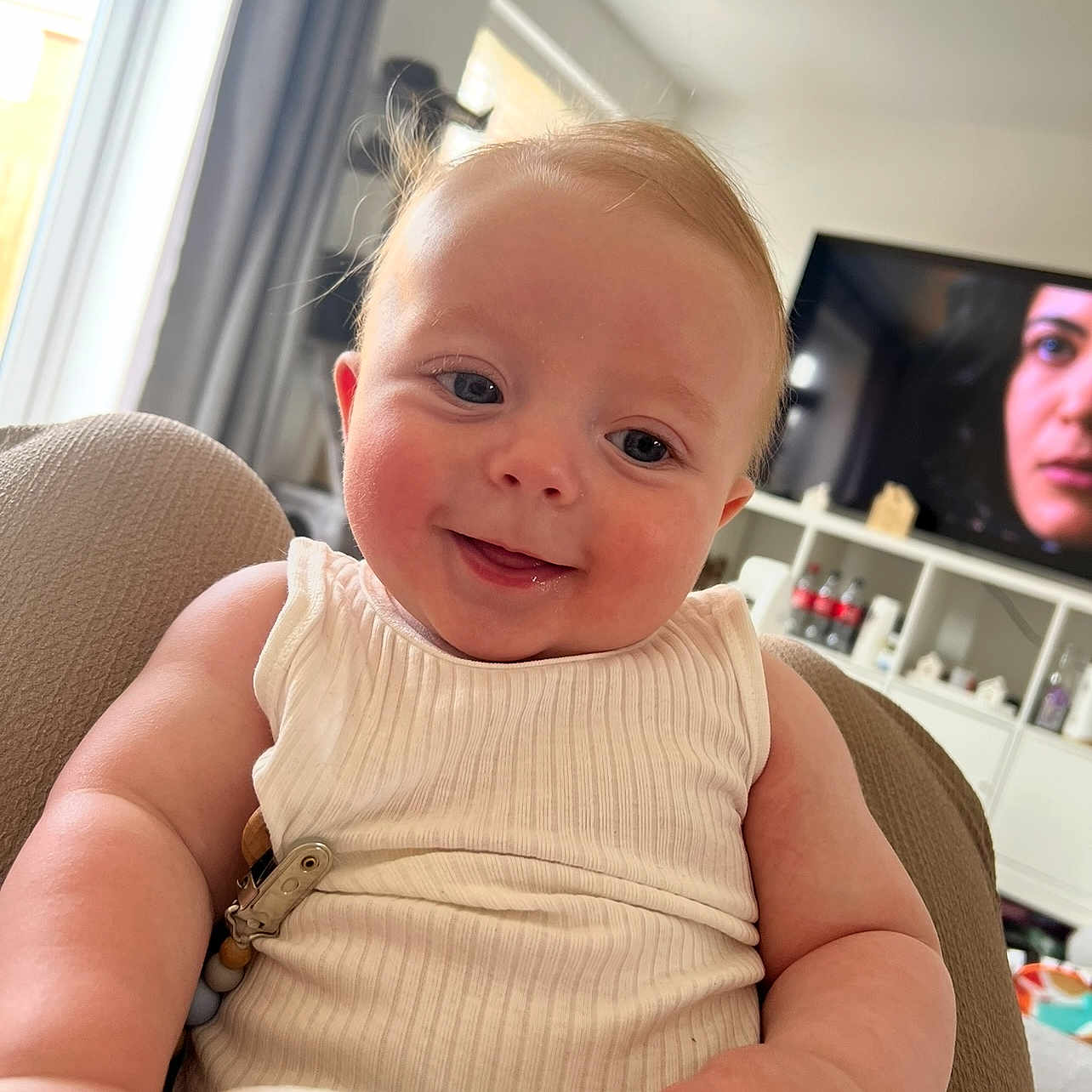 Oakley joined the competition — help win amazing prizes! arm, baby, child, closeup, clothing, comfort, curtain, cute, expression, face, furniture, happy, home, indoor, living_room, person, skin, smile, tank_top, television