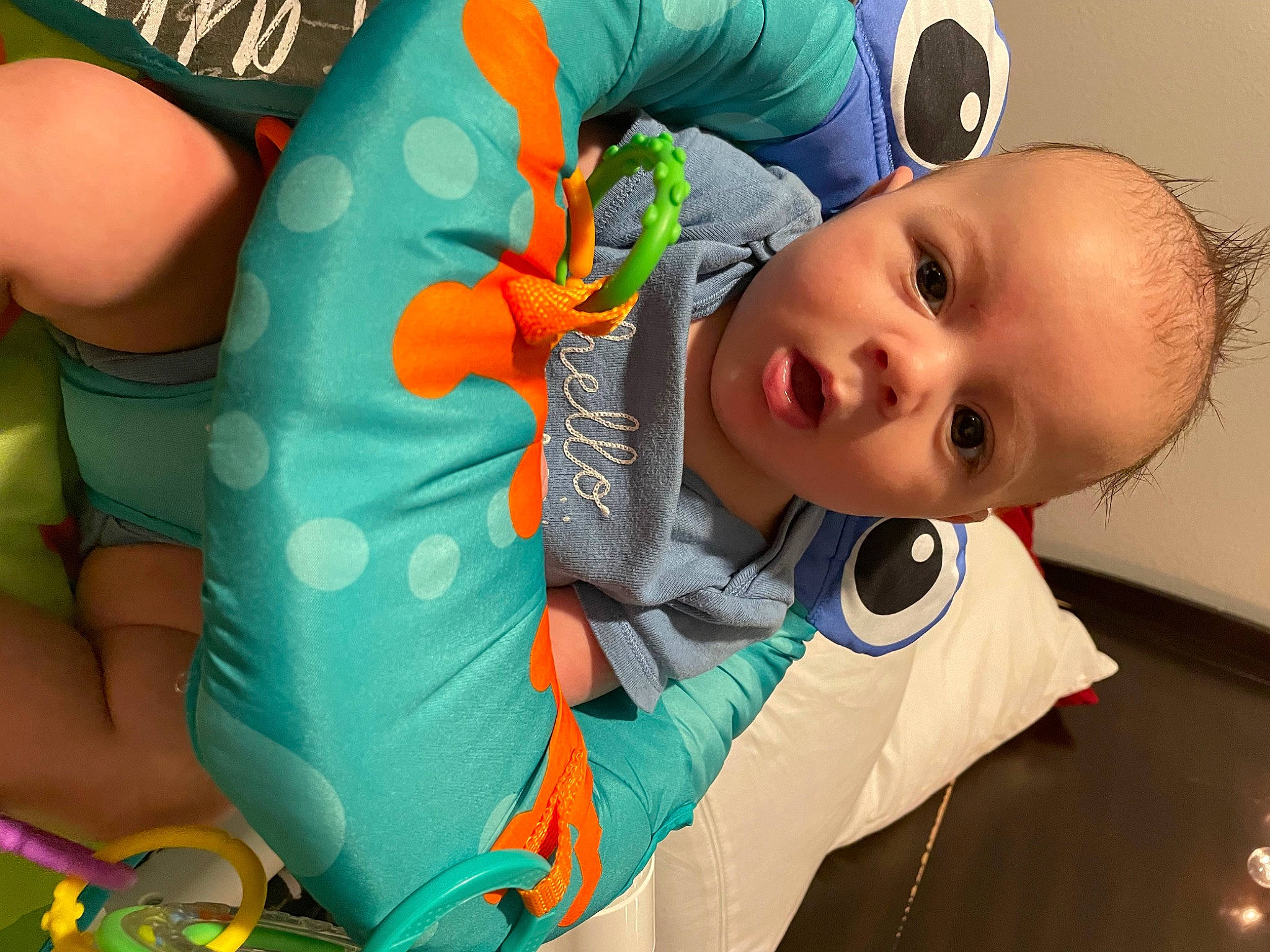 Enzo is registered to the contest to win money with this photo: arm, baby, baby_products, baby_toddler_clothing, child, comfort, finger, hand, happy, human_body, leisure, mouth, neck, nose, orange, person, personal_protective_equipment, skin, toddler, wrist