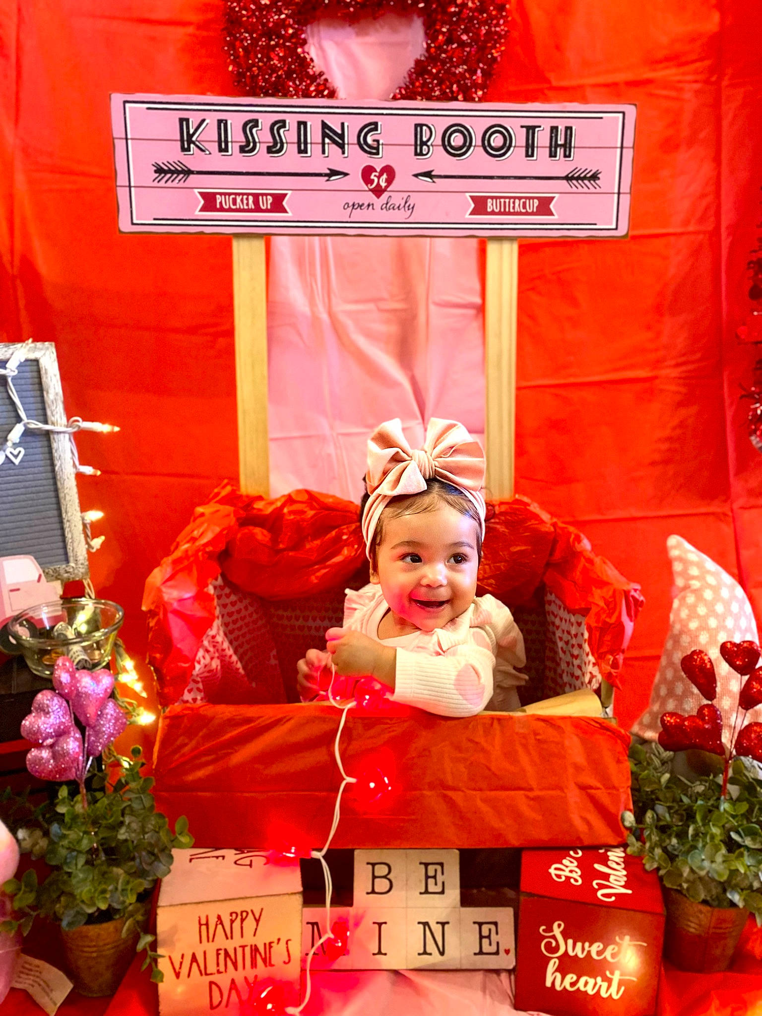 Kahlani is registered to the contest to win money with this photo: advertising, baby, carmine, child, event, flower, flowerpot, font, happy, hat, joy, lighting, magenta, orange, peach, person, pink, plant, red, smile