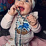 Bayleigh joined the competition — help win amazing prizes! baby, beads, blue_eyes, bow, chewing, child, clothing, cute, face, football, happy, headband, indoor, infant, person, pink_blanket, purse, sitting, smiling, toy