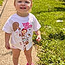 Bayleigh is registered to the contest to win money with this photo: child, toddler, girl, smiling, outdoor, sunlight, sidewalk, grass, park, portrait, standing, pink_clogs, t_shirt, superhero_shirt, blonde_hair, blue_eyes, playful, sunny, shadow, residential_area