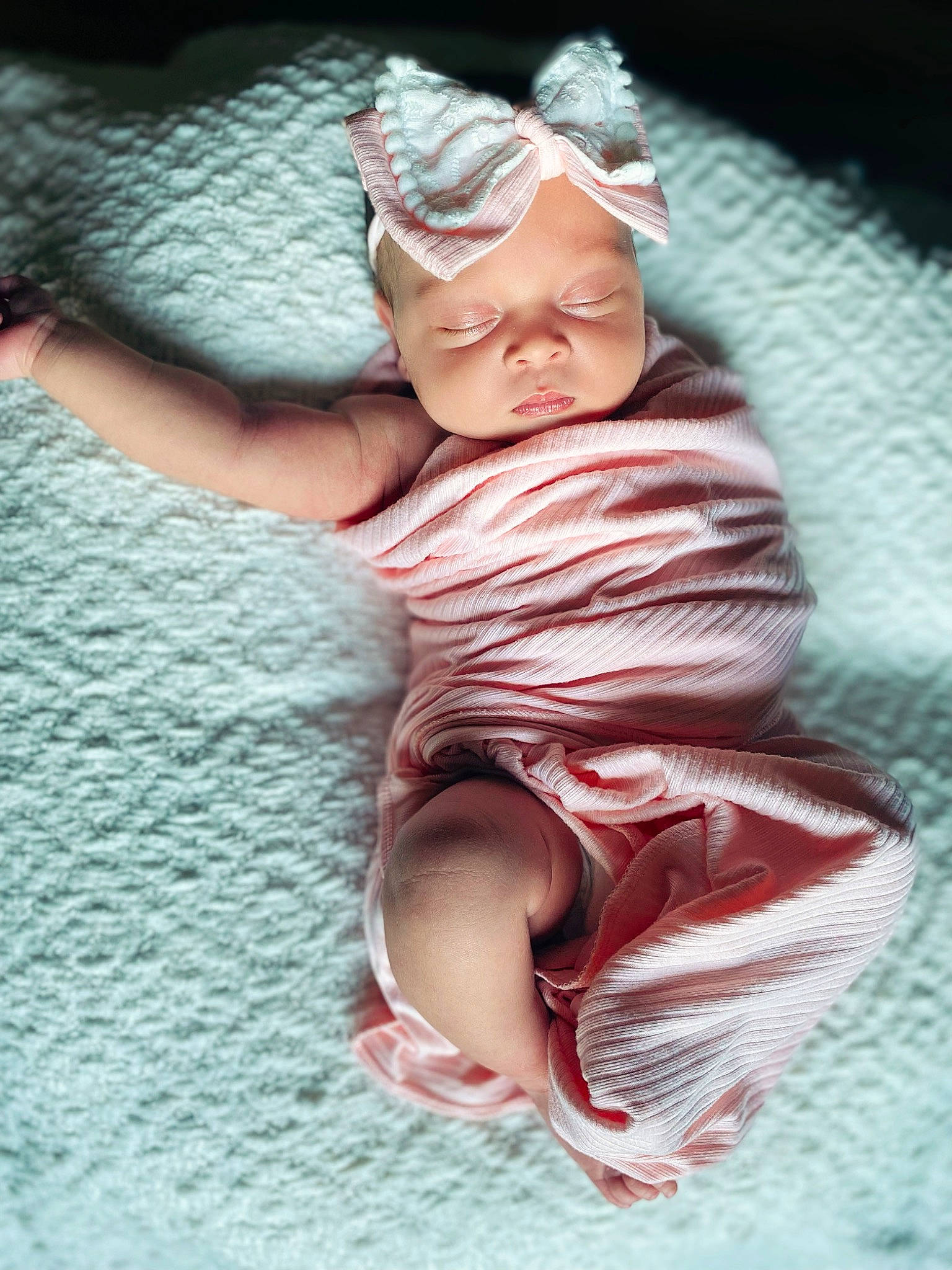 Amelia is registered to the contest to win money with this photo: baby, baby_products, baby_toddler_clothing, child, comfort, eyewear, fashion_accessory, flesh, foot, goggles, happy, headgear, headpiece, headwear, human_body, human_leg, linens, person, pink, sitting