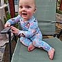 baby, child, pajamas, smiling, chair, outdoor, grass, wooden_deck, hand, foot, face, blue_eyes, happy, clothing, infant, person, daylight, playful, cute, nature