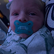 Jesse Jr is registered to the contest to win money with this photo: baby, bedding, blanket, blue_tint, candid, closeup, crib, cute, dim_lighting, eyes_open, face, indoor, infant, newborn, nursery, pacifier, pillow, portrait, sleepy, swaddle