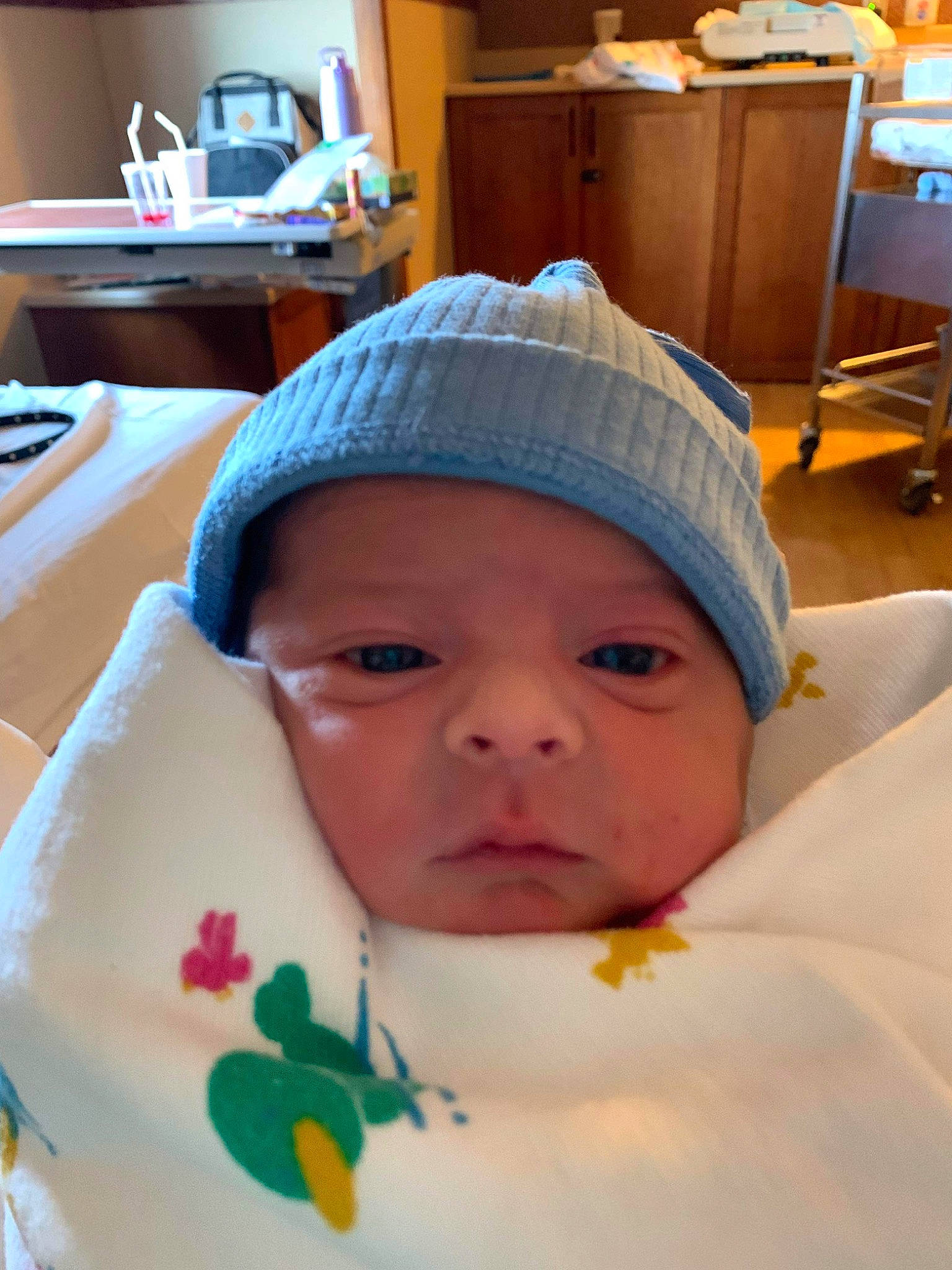 Dakota is registered to the contest to win money with this photo: baby, baby_products, baby_toddler_clothing, beanie, cap, chair, cheek, child, comfort, hat, headgear, headwear, knit_cap, linens, person, room, skin, table, toddler, vacation