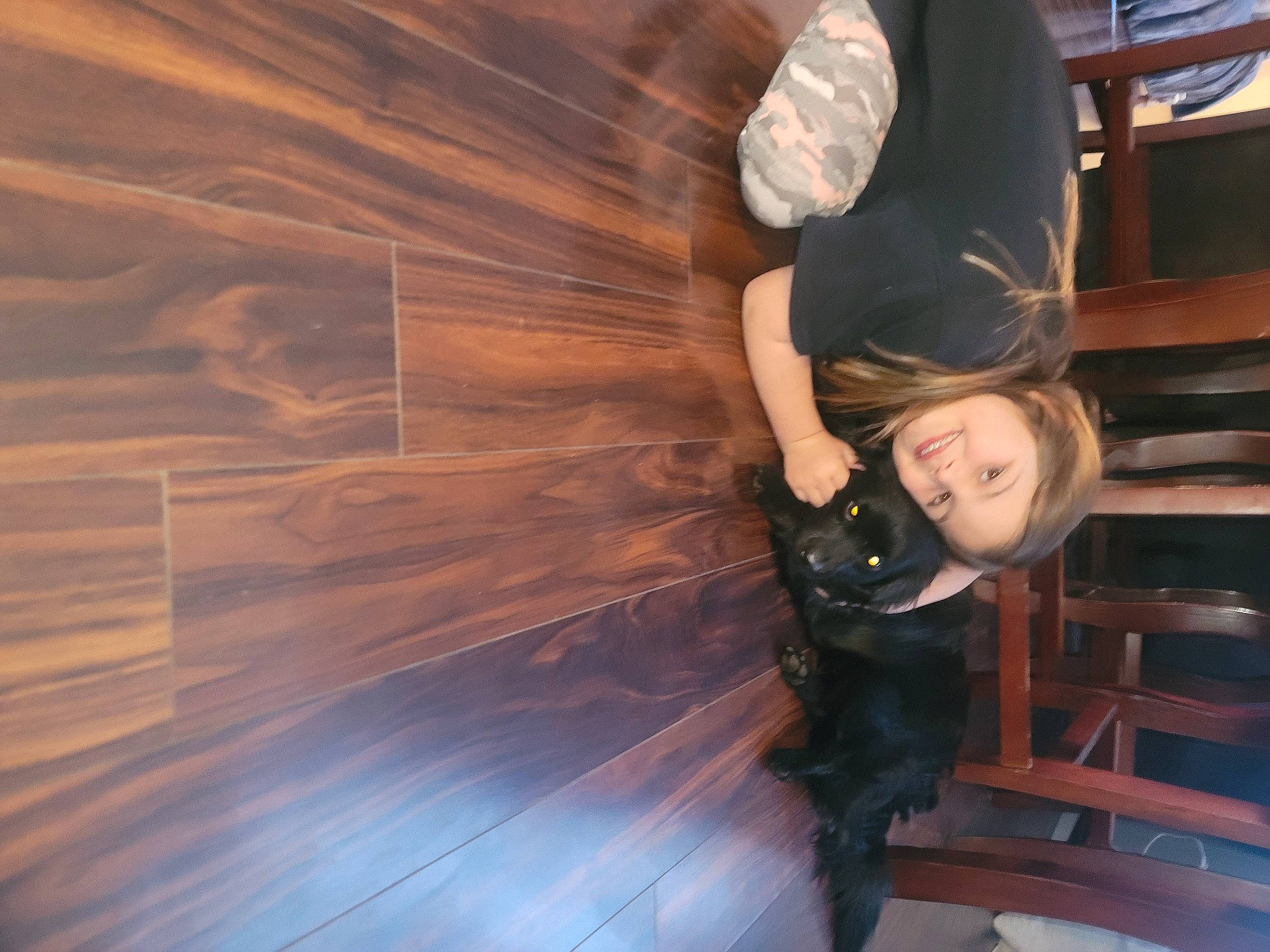 Ella is registered to the contest to win money with this photo: cg_artwork, cool, electric_blue, flash_photography, flooring, fun, happy, hardwood, human_leg, joy, leisure, person, recreation, reflection, shadow, sitting, tints_and_shades, toddler, tree, wing