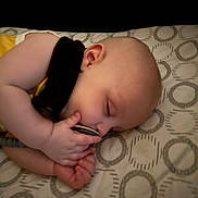 Miles is registered to the contest to win money with this photo: baby, sleeping, pacifier, pillow, infant, hand, face, child, closeup, soft_lighting, bedtime, peaceful, cute, resting, pattern, blanket, young, indoors, peace, comfort