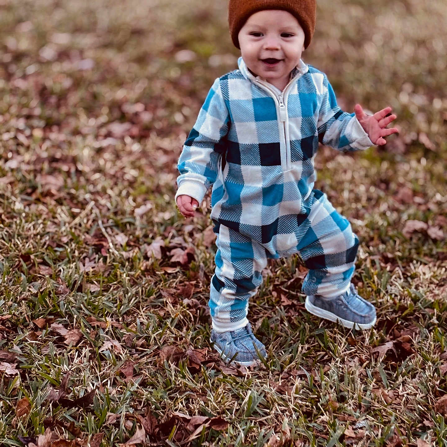 Khoen is registered to the contest to win money with this photo: autumn, baby, beanie, child, clothing, footwear, grass, happy, hat, leaves, nature, outdoor, person, plaid, seasonal, shoes, smile, toddler, walking, young