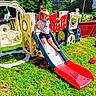 Macelynn is registered to the contest to win money with this photo: active, casual_clothing, child, fence, fun, grass, happy, nature, outdoor, plastic, play, playground, red_ball, shorts, slide, summer, sunlight, toddler, toy, tshirt