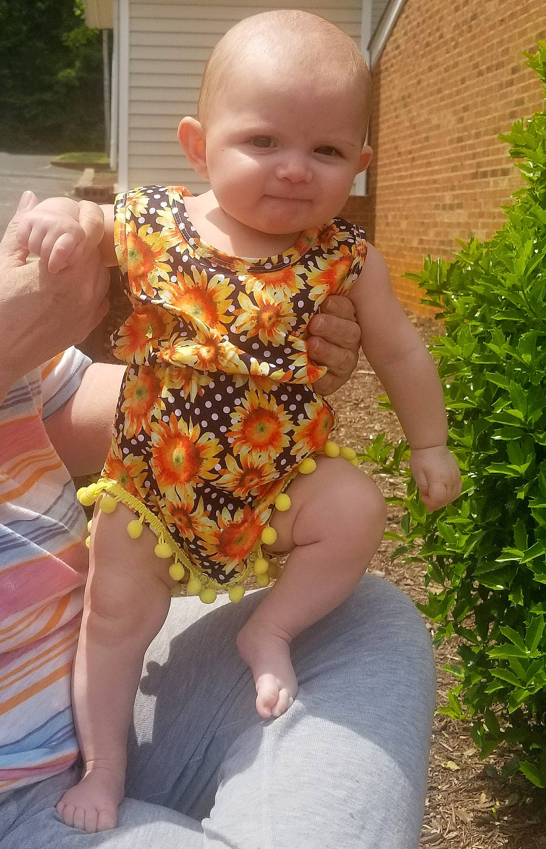 Aniya is registered to the contest to win money with this photo: arm, baby, baby_toddler_clothing, barefoot, child, foot, fun, garden, grass, happy, human_leg, leisure, pattern, person, plant, sitting, smile, thigh, toddler, vacation