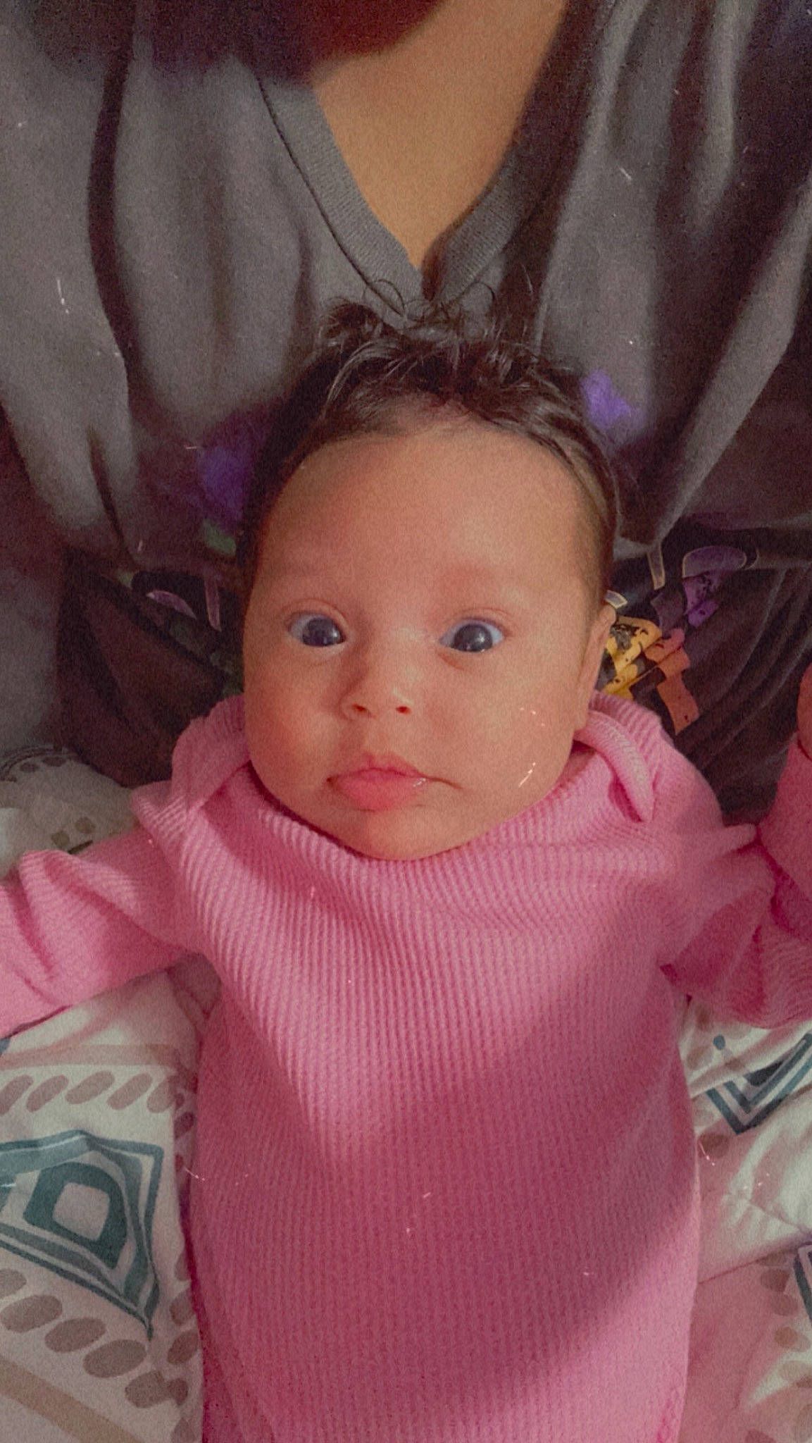 Ava is registered to the contest to win money with this photo: baby, baby_toddler_clothing, cheek, child, ear, eyebrow, eyelash, happy, human_body, iris, lip, long_hair, magenta, nose, person, pink, sitting, skin, sleeve, textile