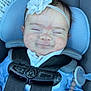 baby, child, car_seat, maxi_cosi, headband, flower, pacifier, smile, closed_eyes, blue_clothing, straps, safety_harness, infant, cute, indoors, person, seat, comfort, resting, happy