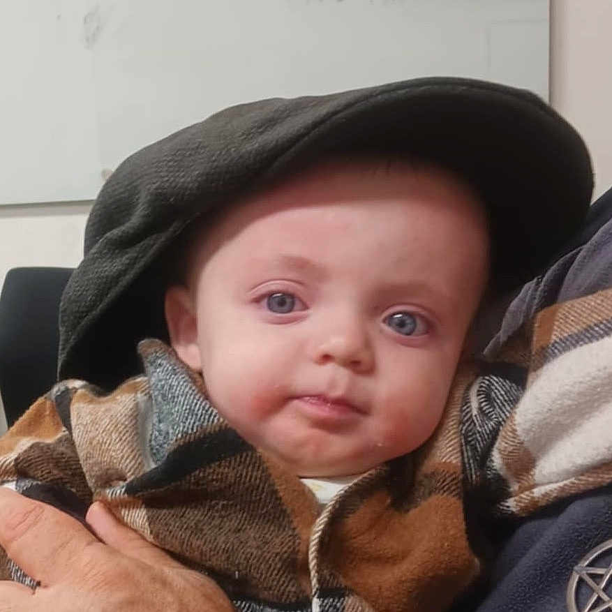 Asher is registered to the contest to win money with this photo: baby, babylaughing, bonnet, clothing, face, happy, hat, head, person, photography, portrait, smile, spitting