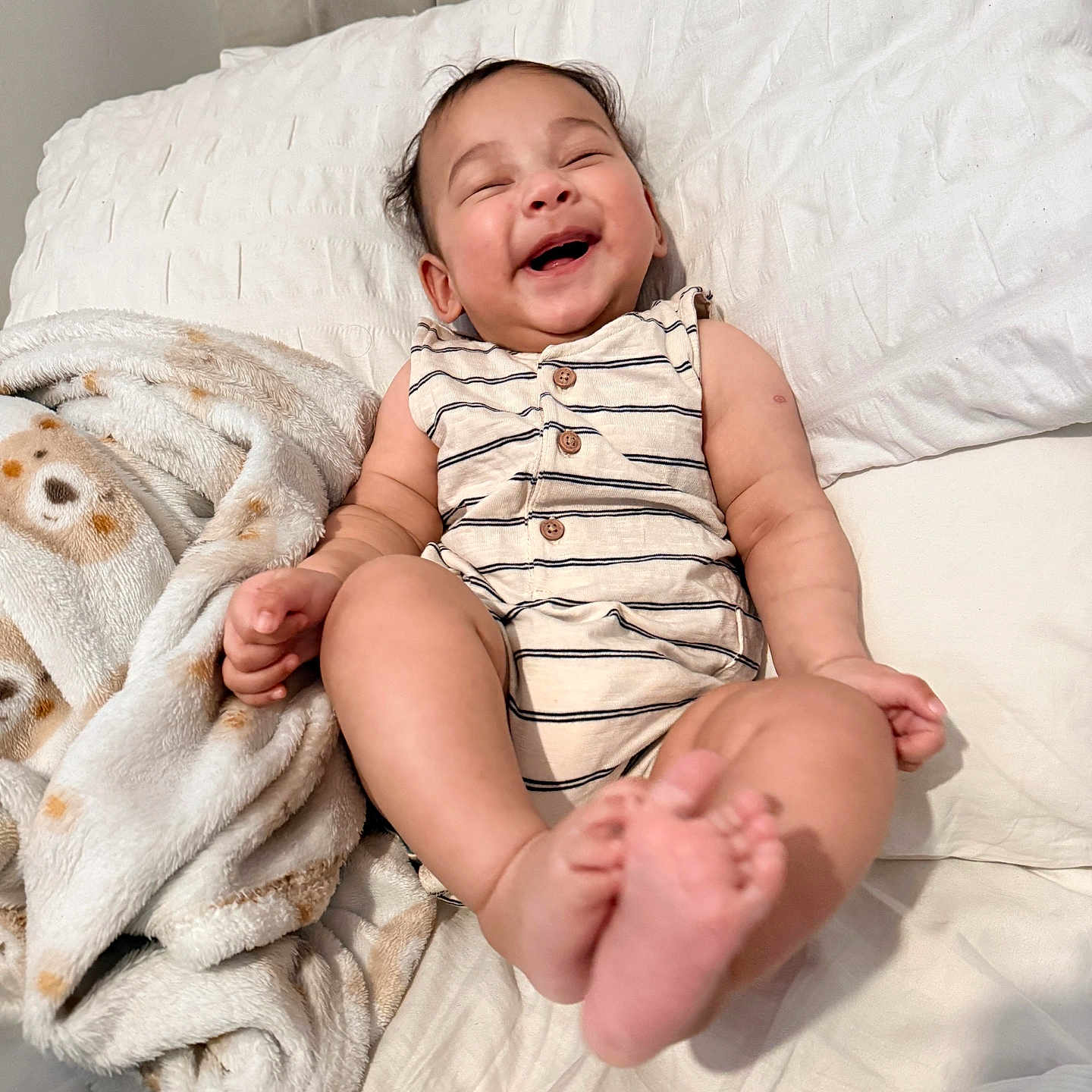 Ryan joined the competition — help win amazing prizes! baby, bed, blanket, buttoned, child, clothing, cozy, cute, face, feet, happy, indoor, infant, laughing, person, resting, smiling, soft, striped, toddler