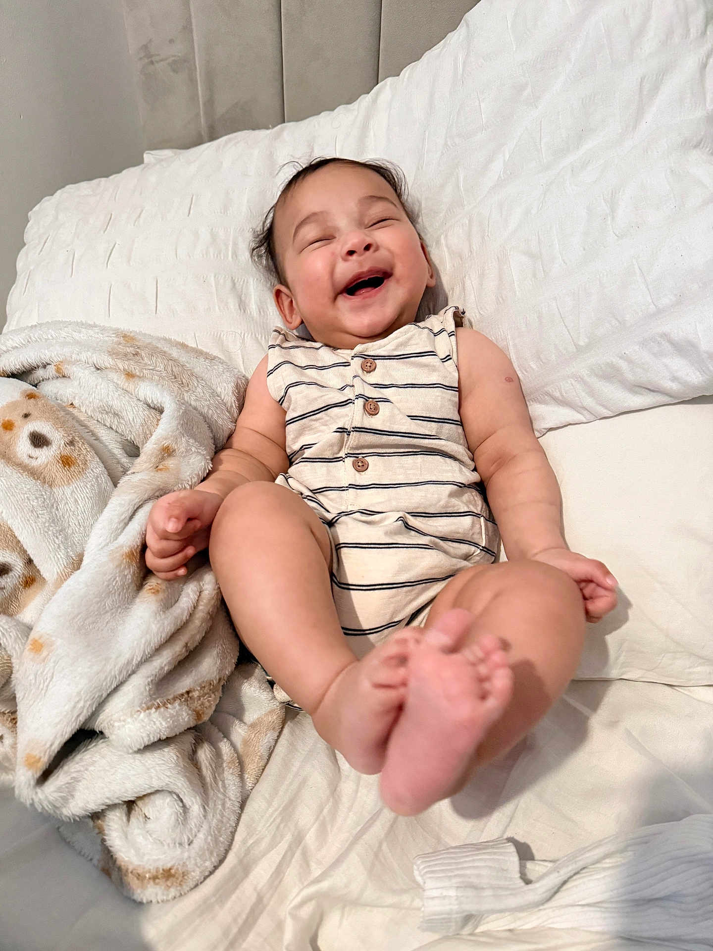 Ryan joined the competition — help win amazing prizes! baby, laughing, smiling, bed, blanket, infant, happy, cute, child, face, feet, clothing, striped, buttoned, soft, cozy, indoor, person, toddler, resting