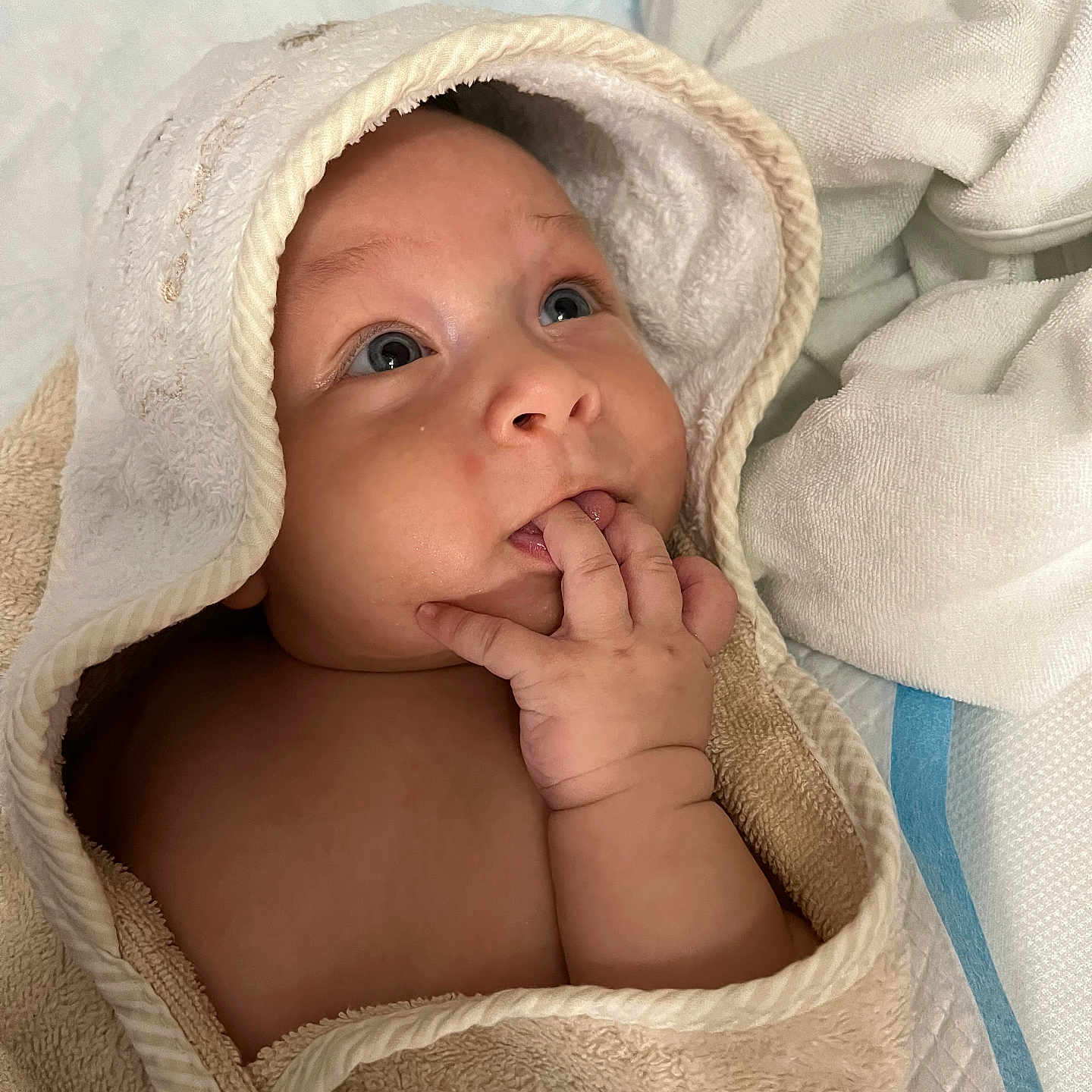 Mark is registered to the contest to win money with this photo: baby, blanket, bonnet, clothing, face, happy, hat, head, hood, newborn, person, photography, portrait, quilt, smile, towel