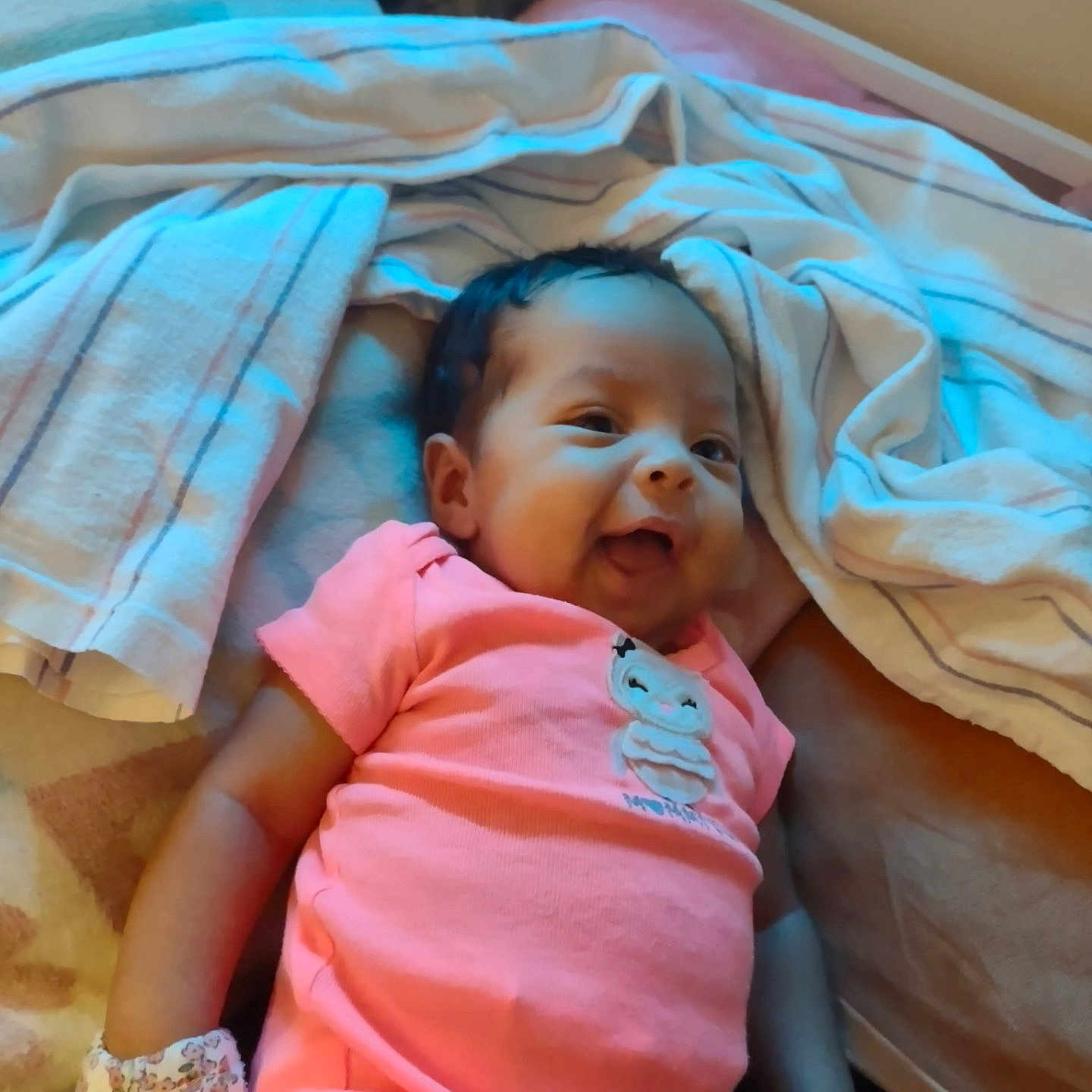 Melody joined the competition — help win amazing prizes! baby, child, infant, smiling, happy, portrait, lying_down, pink_outfit, blanket, bed, bedroom, cartoon, clothing, face, person, indoor, soft_lighting, blue_lighting, baby_shoes, cozy