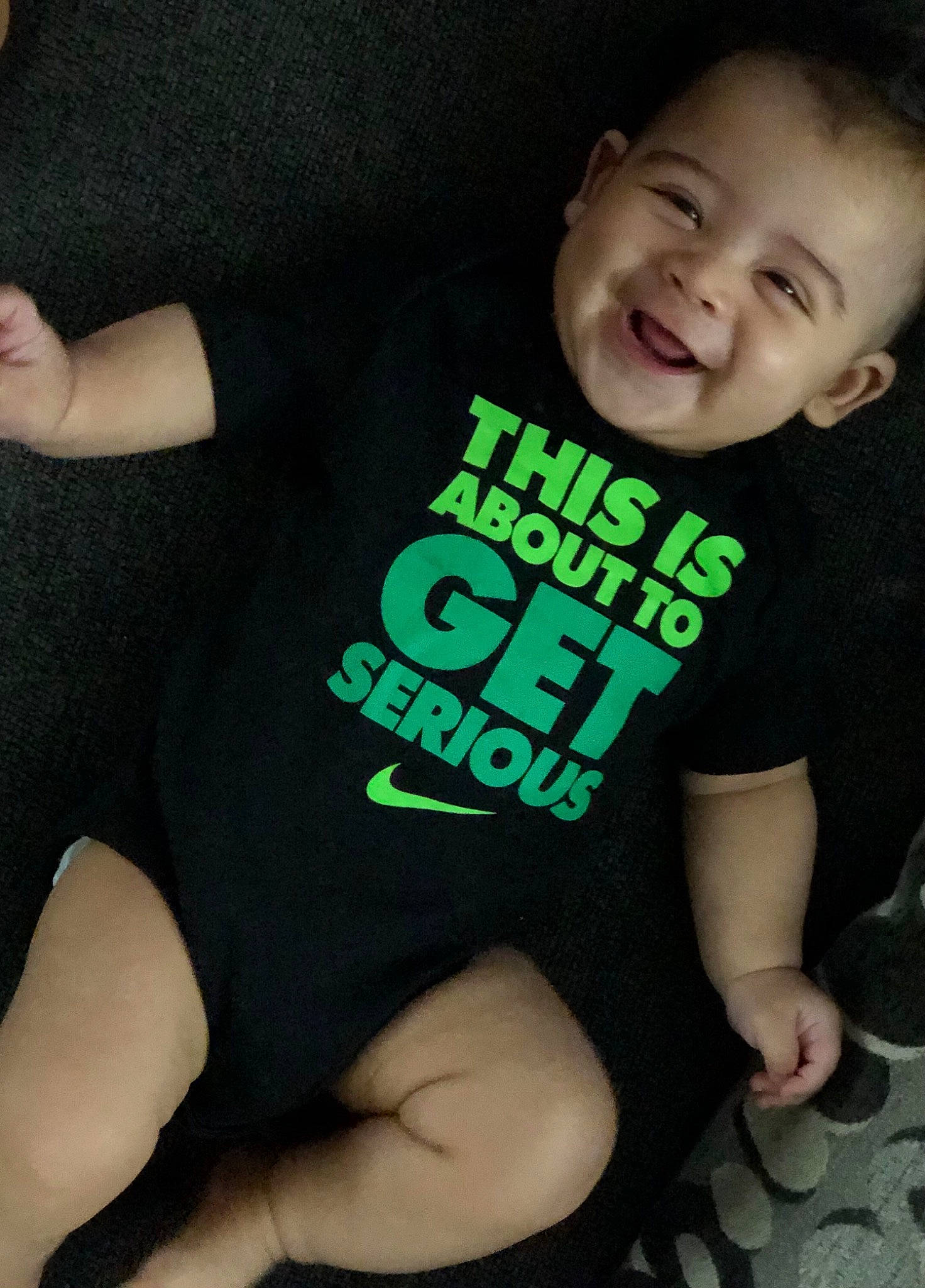 Ryland is registered to the contest to win money with this photo: baby_toddler_clothing, comfort, cool, elbow, finger, font, gesture, happy, head, human_body, joint, joy, knee, leg, muscle, person, sleeve, smile, sportswear, t_shirt