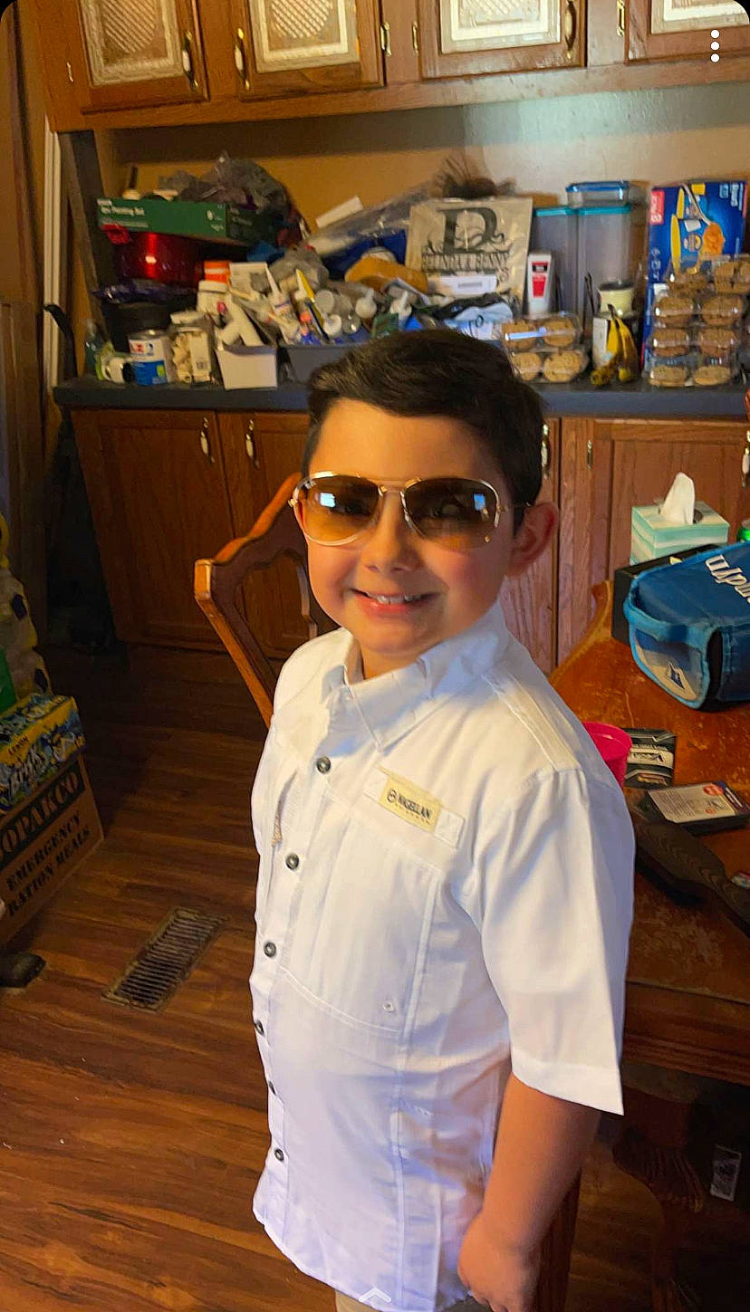 Camdyn joined the competition — help win amazing prizes! aircraft, button, dress_shirt, eyewear, fashion_design, flooring, fun, glasses, goggles, hardwood, joy, person, personal_protective_equipment, room, sleeve, smile, sunglasses, t_shirt, uniform, vacation