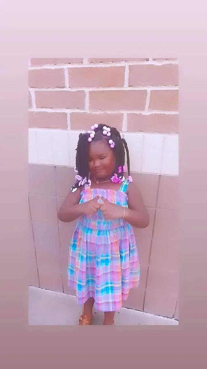 Kennedi is registered to the contest to win money with this photo: baby_toddler_clothing, brick, child, fashion_accessory, fashion_design, fun, happy, magenta, one_piece_garment, pattern, person, pink, plaid, purple, room, sleeve, tartan, toddler, violet, visual_arts