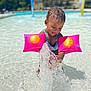 toddler, child, water, splash, pool, floaties, pink, sun_design, summer, outdoor, play, happy, splashing, water_play, swimwear, fun, vacation, sunny, daytime, recreation