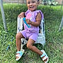 toddler, child, smiling, purple_clothing, outdoor, grass, chair, happy, person, footwear, sandals, fence, sunlight, greenery, shorts, playful, young_child, summer, casual, cute