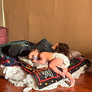 Xander Rebel is registered to the contest to win money with this photo: baby, bed, blanket, brown_hair, casual_clothing, child, comfort, diaper, floor, home, indoor, laying_down, pacifier, pillow, relaxing, resting, sleeping, two_children, wall, wooden_floor