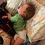 Xander Rebel is registered to the contest to win money with this photo: toddler, sleeping, pacifier, diaper, green_shirt, blanket, pillow, dinosaur_pattern, indoor, cozy, child, bedtime, rest, soft_lighting, cute, nap, infant, baby, comfort, sleep