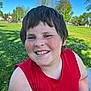 bench, casual_clothing, cheerful, child, daylight, face, freckles, grass, happy, nature, outdoor, park, person, portrait, red_shirt, short_hair, smiling, summer, sunny, trees