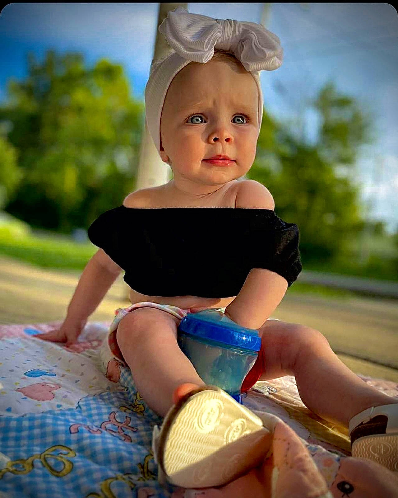 Lakelynn is registered to the contest to win money with this photo: baby_toddler_clothing, child, electric_blue, face, flash_photography, fun, grass, happy, headgear, human_leg, knee, leisure, person, recreation, sitting, sky, sleeve, summer, thigh, toddler