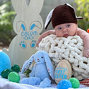 Calum joined the competition — help win amazing prizes! baby, balloon, beanie, blanket, bonnet, cap, clothing, face, glove, happy, hat, head, newborn, people, person, photography, portrait, purple, quilt, toy