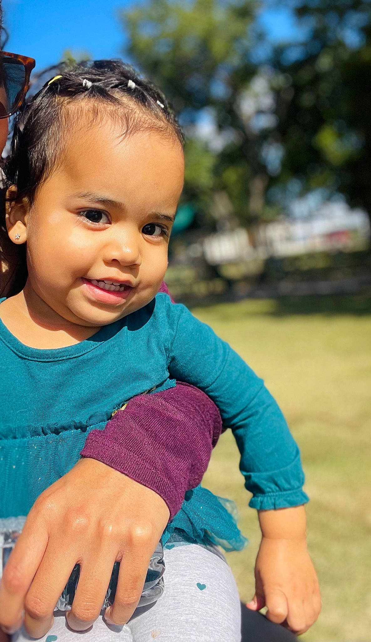 Malayah is registered to the contest to win money with this photo: baby_toddler_clothing, blue, dress, electric_blue, eye, face, fun, grass, hair, hairstyle, happy, head, leisure, lip, person, recreation, skin, sleeve, sunglasses, toddler