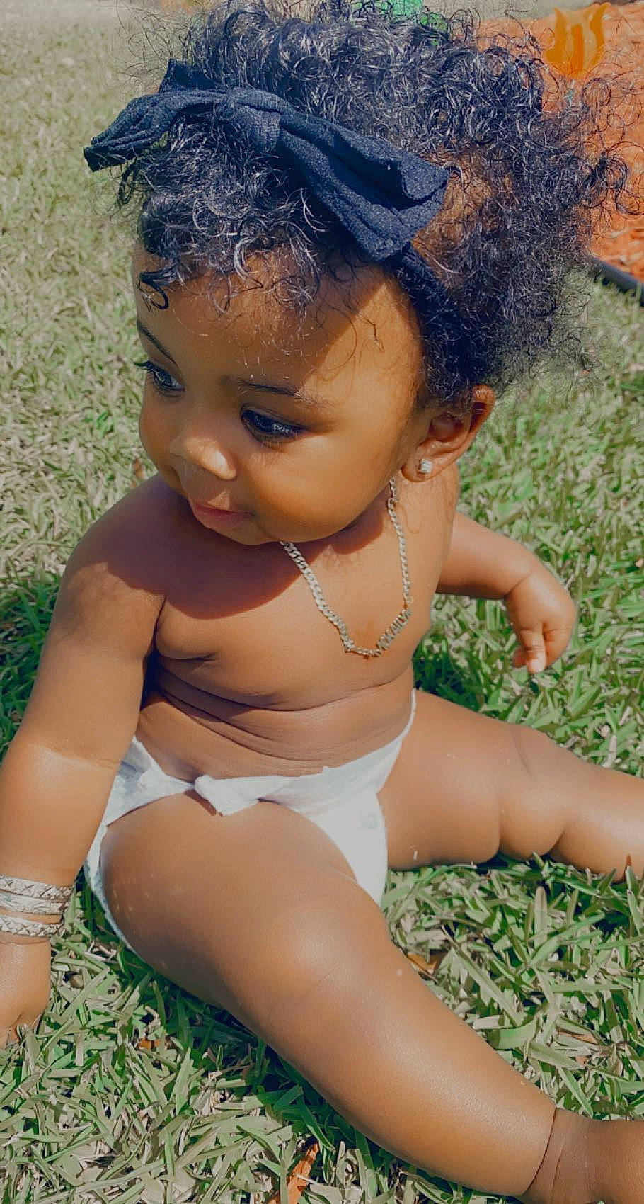 Mckailyn joined the competition — help win amazing prizes! abdomen, baby, beauty, black_hair, chest, eye, eyebrow, face, grass, hair, happy, head, knee, lip, long_hair, people_in_nature, person, skin, thigh, toddler