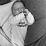 baby, child, closed_eyes, cozy, cushion, cute, face, hand, indoors, infant, monochrome, onesie, peaceful, portrait, relaxation, resting, sleeping, small, soft, text_on_clothing