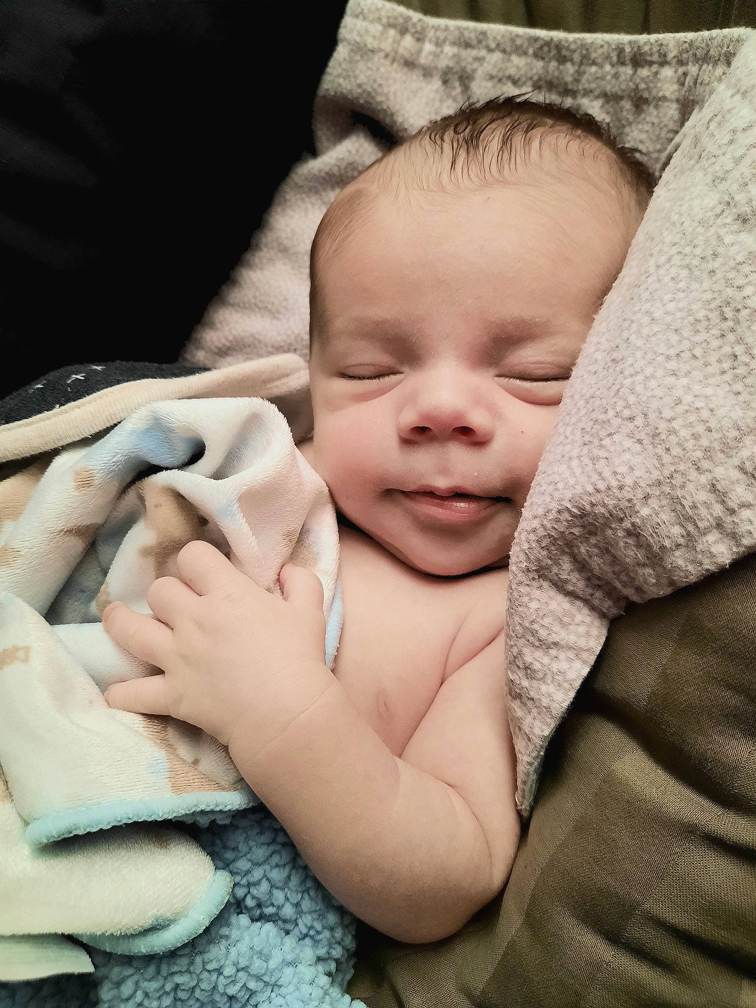 Lucian is registered to the contest to win money with this photo: baby, baby_products, baby_toddler_clothing, cheek, child, chin, comfort, fur, gesture, happy, linens, monochrome, nail, pattern, person, sitting, skin, smile, thumb, toddler