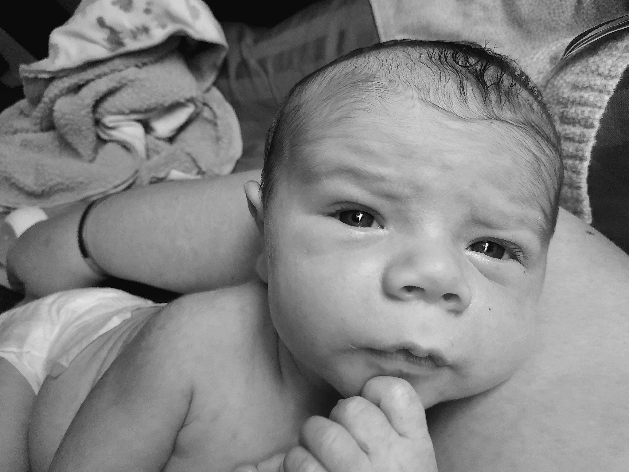 Lucian is registered to the contest to win money with this photo: arm, baby, black, cheek, eye, eyebrow, eyelash, finger, gesture, hand, happy, head, human, iris, lip, mouth, nose, organ, person, photograph