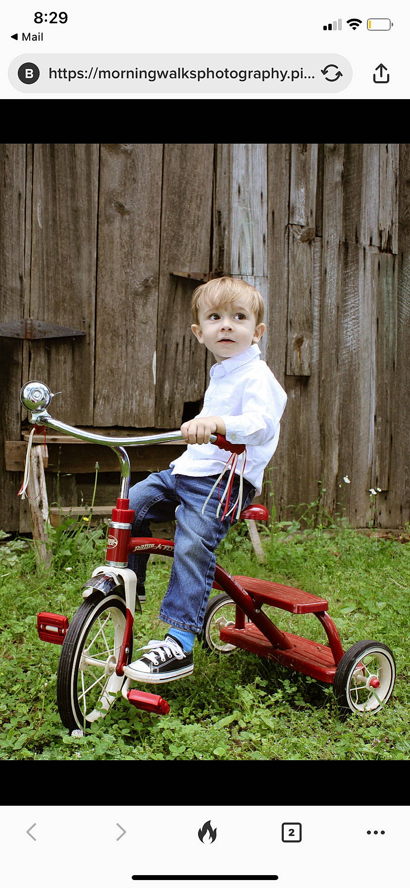 Leo is registered to the contest to win money with this photo: automotive_tire, bicycle, bicycle_accessory, bicycle_frame, bicycle_handlebar, bicycle_part, bicycle_tire, bicycle_wheel, bicycles_equipment_and_supplies, clothing, grass, jeans, people_in_nature, person, photograph, riding_toy, rolling, tire, toddler, vehicle