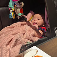Kiara joined the competition — help win amazing prizes! baby, blanket, car_seat, chicken_wings, child, colorful, cozy, cute, face, food, happy, indoor, infant, pink, plate, rolls, smile, soft, table, toy