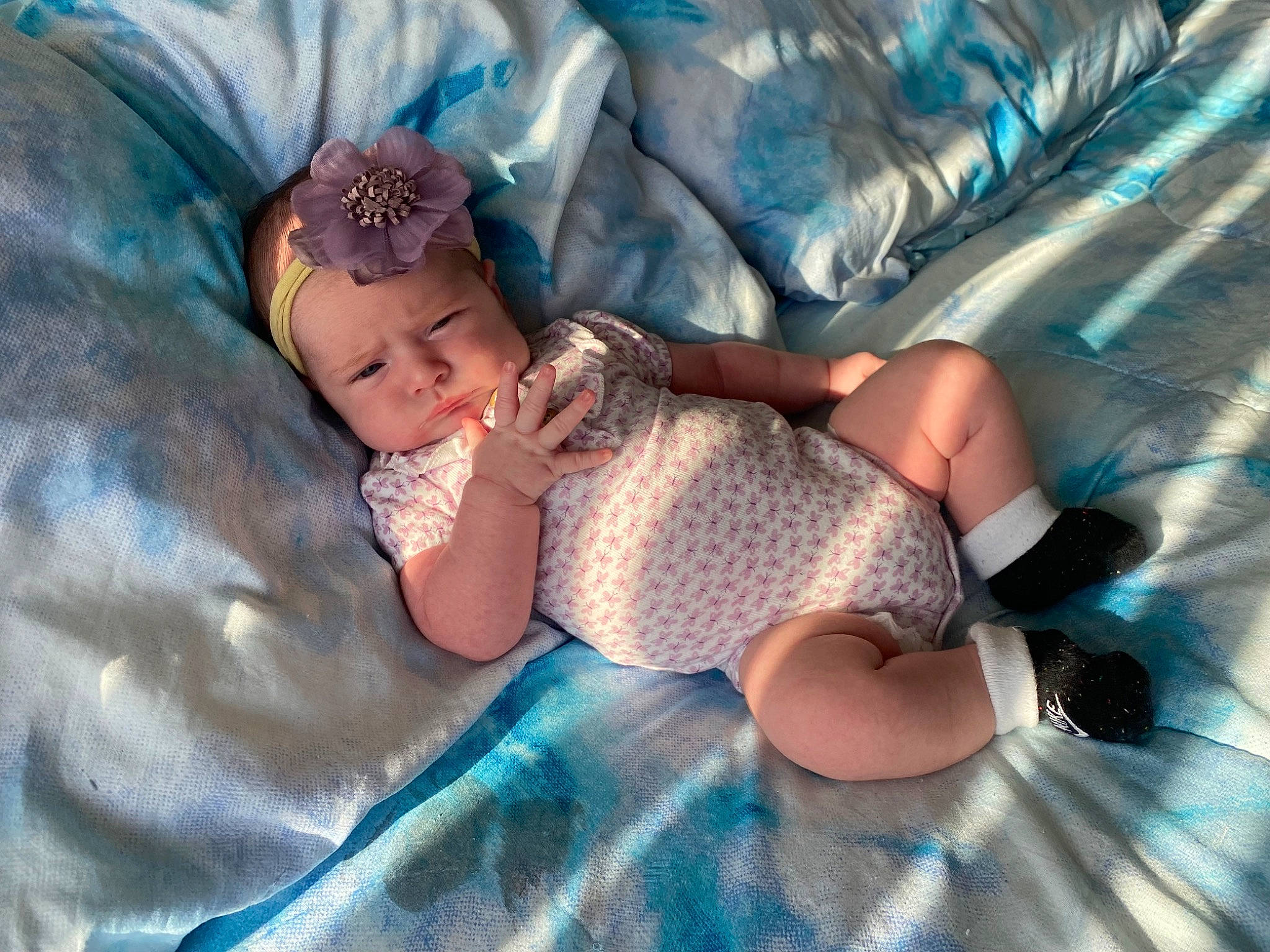 Ava joined the competition — help win amazing prizes! baby, baby_products, baby_toddler_clothing, child, comfort, electric_blue, fashion_accessory, finger, foot, fun, grass, headwear, human_leg, leg, leisure, linens, pattern, person, sitting, sock