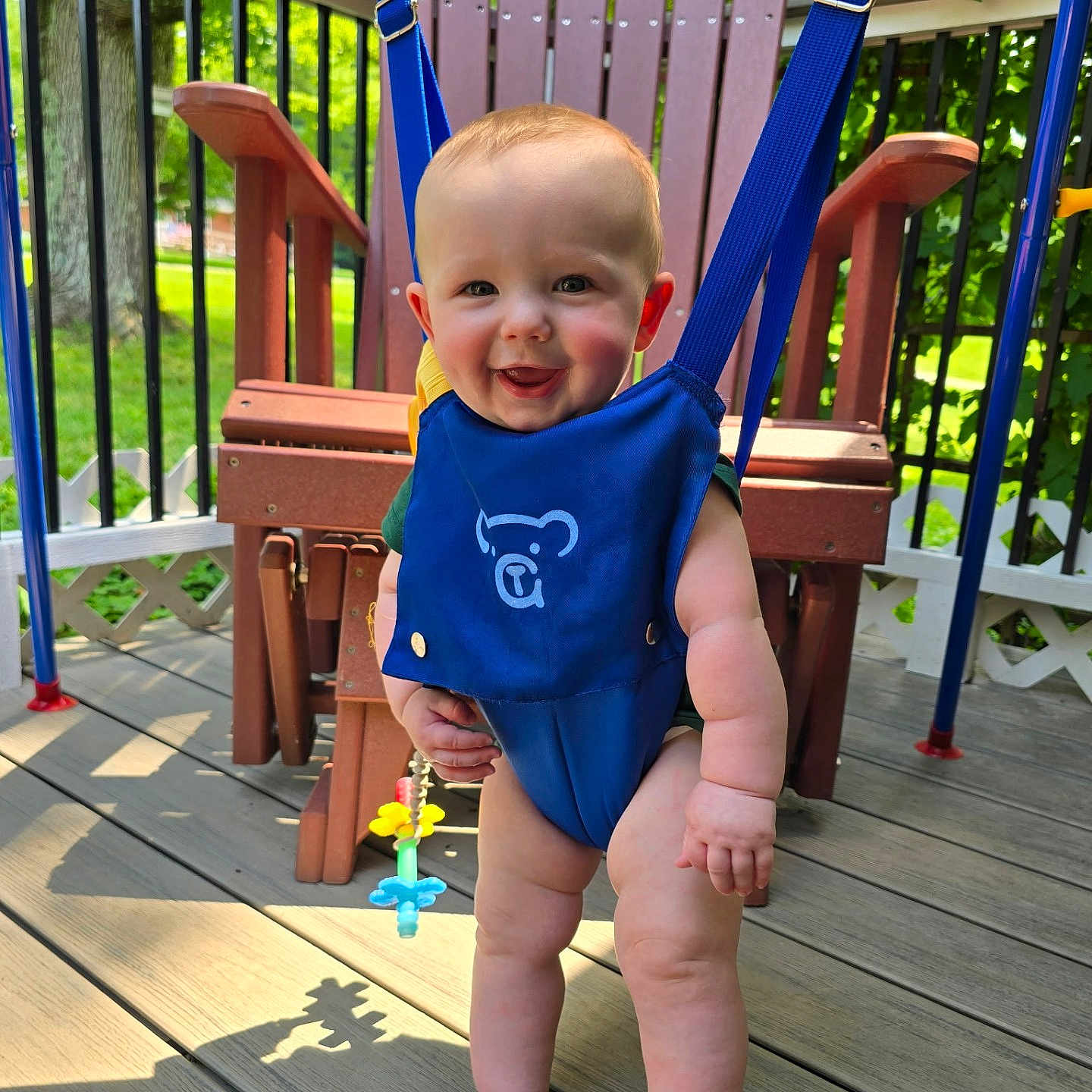 Grayson joined the competition — help win amazing prizes! baby, blue_jumper, child, cute, daylight, deck, face, greenery, happy, infant, legs, outdoor, playtime, portrait, smiling, summer, sunlight, swing, toes, wood