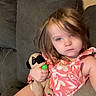 toddler, child, plush_toy, pug, couch, diaper, pink_top, indoor, relaxed, blue_eyes, brown_hair, casual, furniture, home, person, comfort, sitting, soft_toy, expressionless, living_room