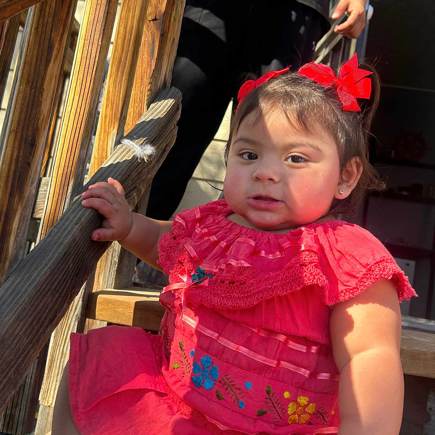 Jasmin is registered to the contest to win money with this photo: architecture, baby, bodypart, building, clothing, dress, face, finger, hand, handrail, head, house, housing, outdoors, person, photography, plywood, porch, portrait, wood