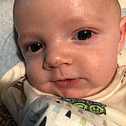 Mason is registered to the contest to win money with this photo: baby, closeup, face, infant, blanket, cute, child, young, skin, expression, eyes, portrait, indoors, soft, clothing, sleepwear, newborn, person, head, resting