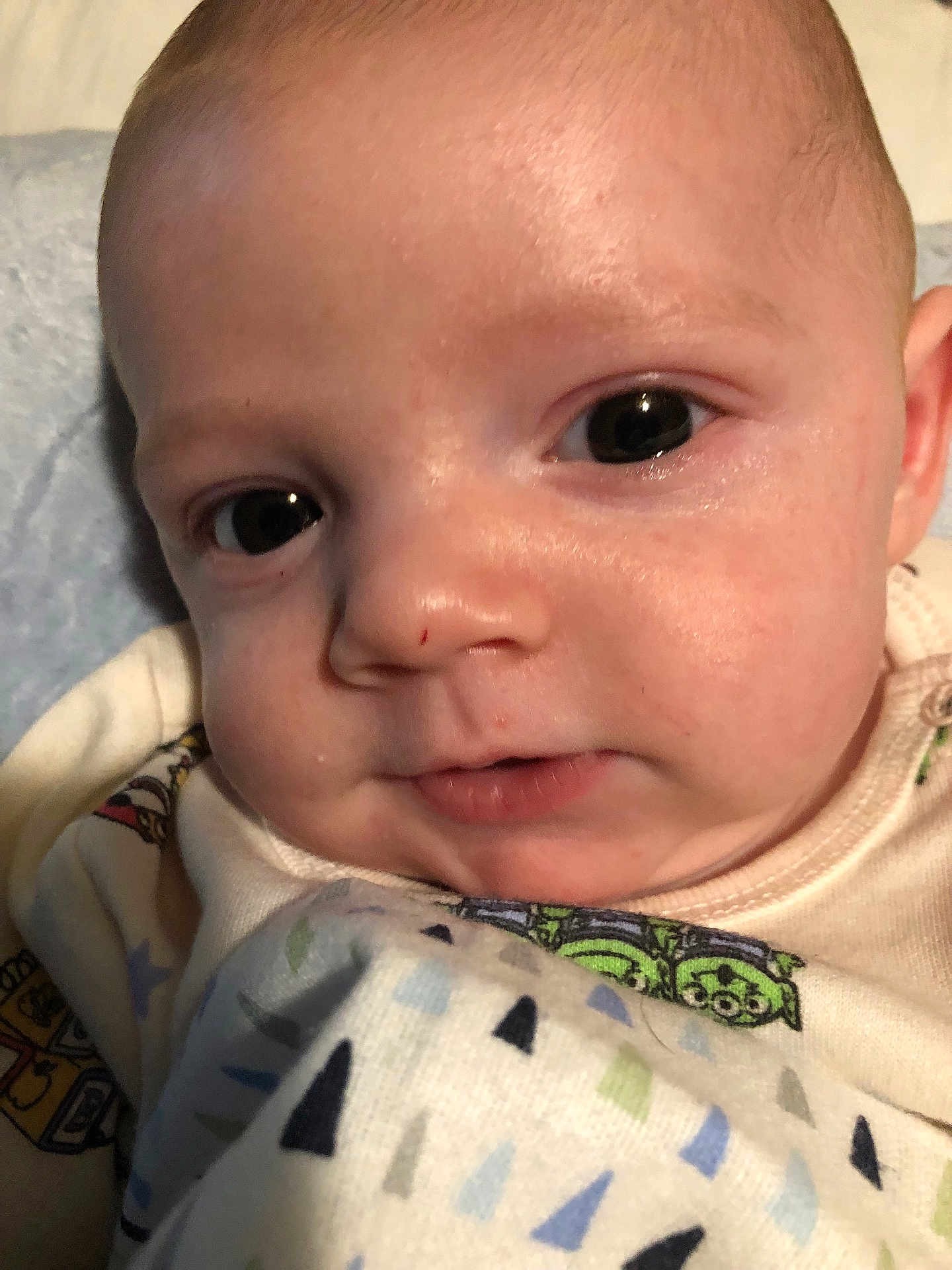 Mason is registered to the contest to win money with this photo: baby, closeup, face, infant, blanket, cute, child, young, skin, expression, eyes, portrait, indoors, soft, clothing, sleepwear, newborn, person, head, resting