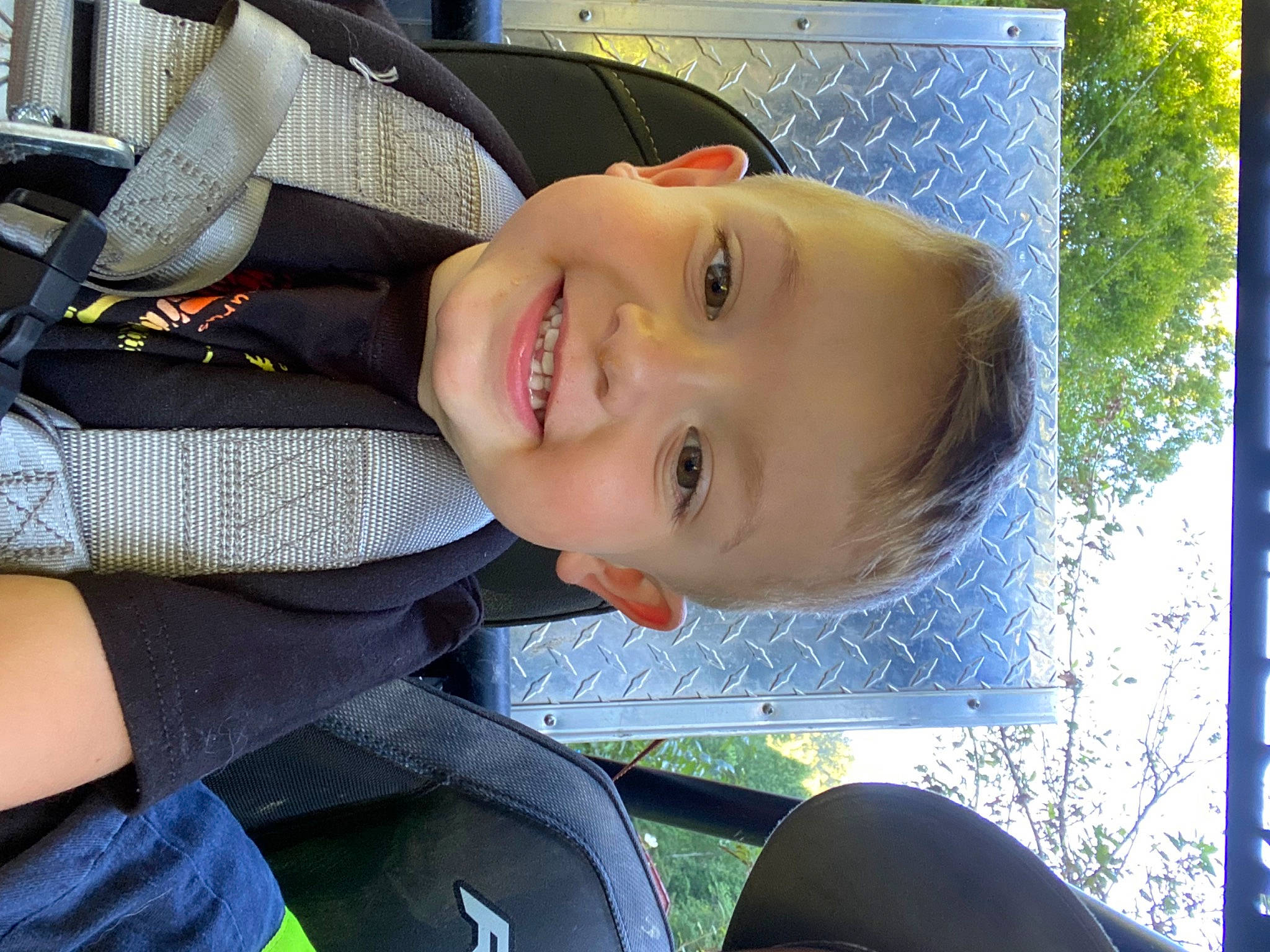 Layne is registered to the contest to win money with this photo: auto_part, baby_products, car_seat, child, cool, electric_blue, facial_expression, family_car, fun, grass, happy, joy, laugh, leisure, nose, person, product, smile, toddler, tree