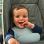 baby, child, smile, high_chair, bib, clothing, hand, face, happy, infant, indoor, person, portrait, seat, young_child, cute, playful, skin, head, sitting
